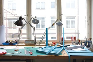 An advanced mock-up for the stackable outdoor chair he's designing for Piazza San Marco in Venice sits on a workstation.