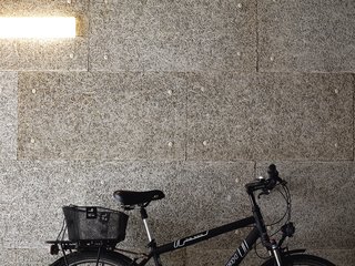The lobby-cum-garage plays home to the couple’s favorite forms of transport: <br><br>a bike and Spiekermann’s Audi.