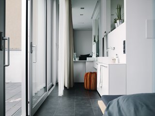 The bedroom and bathroom make up the private zones on the top floor.