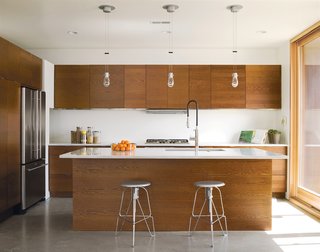 Pasta Carbonara - Photo 4 of 4 - The family's 150-square foot kitchen features Carrara marble countertops—perfect of pasta-making, John says. The stools are the Covey Stools by Jeff Covey.