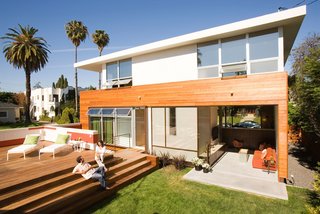 A large wood platform over the sunken garage serves as an outdoor gathering space.