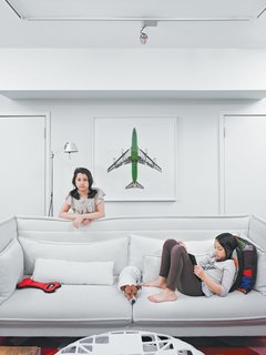 A photo from Jeffrey Milstein’s Aircraft series hovers behind the Alcove sofa (which is terrier Leica’s favorite place to sit) by Ronan and Erwan Bouroullec for Vitra.