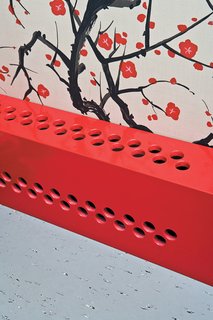 The partial renovation gave Dine a few opportunities to experiment with future designs, like his custom radiator covers. Installed throughout the apartment to mask the old pipes, they’re made from simple medium-density fiberboard panels (white in the living room and red under the wallpaper) that were CNC-milled with a dot pattern. Like the two storage towers in the living room, the covers consist of basic construction materials that Dine punched up with a coat of paint and a graphic detail.
