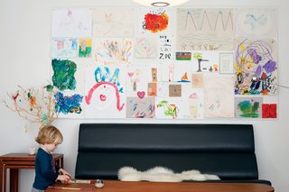 Ari plays in the art area of the dining room.