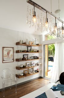 The lantern addition is utilized mostly as an open dining room leading to the patio and pool beyond. Misra and Pande worked with the couple’s existing furniture, such as the Philippe Starck Ghost chairs, and helped integrate new elements such as the custom-made chandelier.