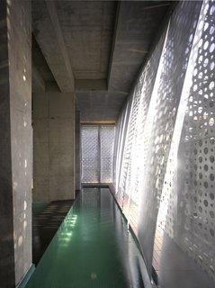 A Modern Aesthetic in Mumbai - Photo 14 of 17 - The pull-down scrims over the lap pool move with the breeze within the public space.