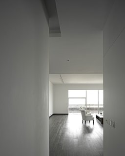 A Modern Aesthetic in Mumbai - Photo 15 of 17 - The owner's apartment, which incorporates a double-height space in some areas, has teak floors, whereas the other units have more industrial concrete floors.