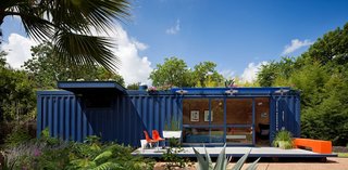How to Buy a Shipping Container - Photo 5 of 12 - While shopping for containers, Hill was instantly drawn to this one’s existing blue color and chose to buy it and leave it as is. Poteet added floor-to-ceiling sliding doors to allow light in, as well as a cantilevered overhang to shade a window on the left side, which houses a small garden storage area.