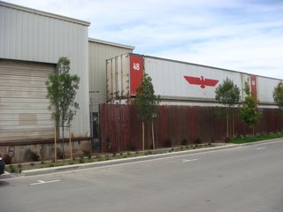 The development is bordered by industrial zones with merely a street as a buffer. Shipping containers to the south of the site serve as a reminder of Tassafaronga's context. Bridget Galka, who is the senior development director for the Oakland Housing Authority, says that the position of the development on the cusp of residential/industrial zones allowed for more potential to develop the area.