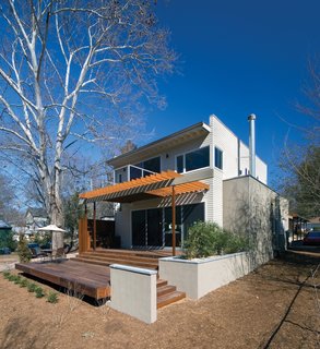 Instead of demolishing the existing house or adding a second story, the addition was added at the rear of the existing structure, separated by a new main entry courtyard. These new, public spaces take advantage of a connection to outdoor spaces at the rear of the lot.