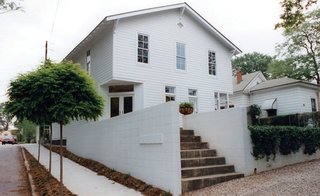 The building structure is a balloon-type frame supported by a central beam and columns. While the original look and proportions of the second floor elevations were maintained, the patch-worked walls below were redesigned to complement the upper story.