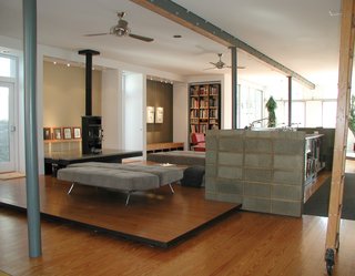 A floating platform defines the living zone and a concrete block wall surrounds a new commercial kitchen (a reference to the old store’s huge penny candy counter).