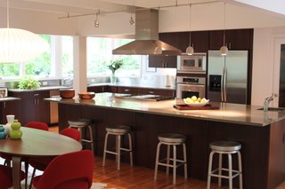 A screened porch and the kitchen were connected and are situated to enjoy southeast light and views of the site.