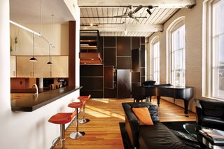 Angerio Design brought a spatial concept to the Stratton residence born from a desire for efficiency, openness, and storage. Utilitarian functions including desk space, photography print storage, laundry, toilet, shelving and drawers are all condensed into a single volumetric element that allows primary function areas to remain as spacious as possible.
