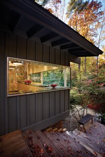 The house is transformed by inserting a minimalist glass corner into the kitchen. This single move creates a sculptural statement that becomes a foreground element and allows the rest of the house to become background to the glass form.