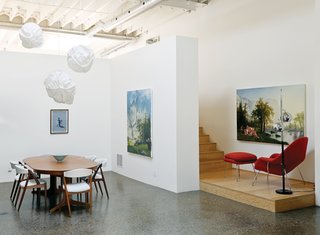An Eero Saarinen Womb chair and a vintage floor lamp hang out on the downstairs landing.