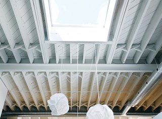 Skylights provide crucial natural light in the dining area and bedroom.