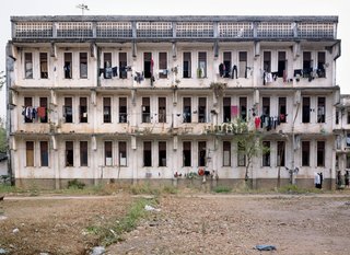 Living in Laos - Photo 6 of 14 - A view of the dorms at the National Polytechnic Institute in Vientiane. Built in 1984 with the help of Soviet engineers, these dorms accommodate students from around the country who come to study in Vientiane. Rooms have four to six bunk beds; bathrooms and washing areas are outside, at a distance from the buildings. I could tell which was the girl’s dorm from the clothes hanging out to dry on the balconies.