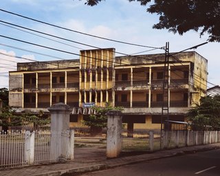 Living in Laos - Photo 8 of 14 - I love the way the vertical facade element with the zig-zaggy canopy keeps my eyes coming back to the center—definitely some mid-century elements. This building is next to the Sacre Coeur church in the old part of town and was probably built by USAID in the 1960s. It was a Catholic school for many years and is now a public middle school.