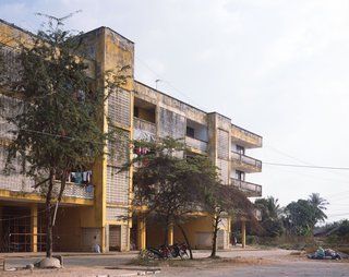 Living in Laos - Photo 3 of 14 - This building reminds me of a Constructivist structure plopped down on Lao soil. Back in the 80s, I am sure it symbolized socialist progress and brotherhood. Today, the Soviets are gone, and the building is falling apart and the trash is piling outside—an apt metaphor for most foreign aid to Laos (and most developing countries, for that matter.)<br><br>To see more of Marc's photography, go to Marc Henrich Projects