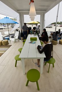 Hyundai Ride and Drive - Photo 7 of 16 - A portion of the main outdoor area features flooring by Lonseal, outdoor furniture by Loll Designs, West Elm ottomans, and flexible bins by Tubtrugs.