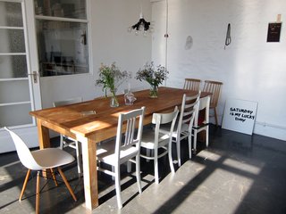 The Sight Unseen gals' personal approach to coverage is evident in their thoughtfully curated slideshows. Khemsurov spent the summer staying at the Berlin loft shared by designers Judith Seng and Alex Valder, and the following are a few shots from her stay (the entirety of which can be seen here). From Khemsurov : "The apartment's huge kitchen offers seating for 10, on an assortment of found chairs Seng painted gray for a previous project. The pendant lamp was assembled by Valder from dual sockets he collected at American hardware stores."
