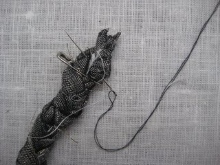 Braided Rag Vessels - Photo 5 of 14 - 3. Undo the knot and braid the remainder of strips at that end. Attach a safety pin securely to either end of the 10' braid. With scissors, trim each end at an angle. Using your needle and thread, sew each end of the braid to secure it and remove each of the safety pins.