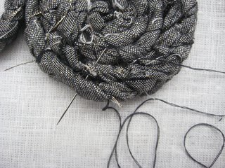 Braided Rag Vessels - Photo 7 of 14 - 5. Using your needle and thread, make small stitches between the braided rows of the coil to secure. Remove the pins when complete.