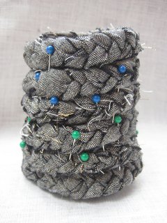 Braided Rag Vessels - Photo 9 of 14 - 6. When the base is secure, you will start building the vessel upward. Holding the excess braid so the flat side is facing out and is uniformly flush, coil the braid on top of the base, pinning each row into place as you go.