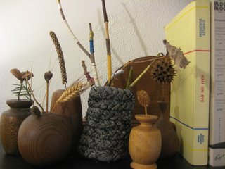 Braided Rag Vessels - Photo 12 of 14 - And here's my little mantle tableau. I put some twigs wrapped in embroidery floss in there for a bit of color, and surrounded it with some wooden bud vases that my grandpa made. Lookin' good! This project was seriously perfect for a drizzly afternoon indoors. The next one I make I'll try with a softer knit that might have less strays threads to trim away in the end, and it's tilting a little, so I will make sure that when I'm pinning it up it stays straight. Loads of fun, though, and I'd very highly recommend trying out your own textile vessels.