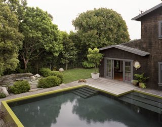 Once in the pool, however, it feels more like the ocean. As with a shelf, the bottom drops quickly from three feet to the nine-foot deep end. A set of three long, shallow steps sits above the middle depth like a sandbar at high tide, the top tread covered with just a few inches of water.