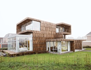 This Home Takes Recycling to the Next Level - Photo 6 of 13 - From the outside, the house appears as a composition of cubic volumes that barely hints at its reused nature. Expanses of glass, skylights, terraces, and balconies all strengthen the relationship between inside and outside and make the interior uniformly light.