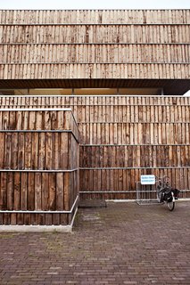 This Home Takes Recycling to the Next Level - Photo 8 of 13 - The facade is clad with 600 recycled cable reels. According to Jongert, "It took about seven minutes to dismantle each one, yielding quite a lot of wood each time." The wood was heat-treated at high temperatures, a natural weatherproofing technique.