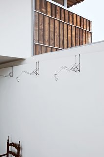 This Home Takes Recycling to the Next Level - Photo 10 of 13 - Looking for a creative way to light Blans's painting collection, the architects collected old, broken umbrellas from Utrecht residents, and transformed them into whimsical and adjustable halogen lamps that latch onto the interior walls.