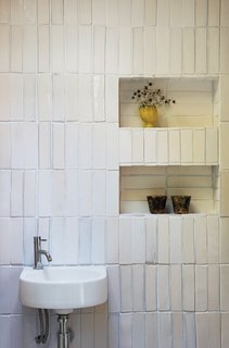 Renovating the old mill was a family effort, and Blee called on his sister Kate, a textile designer based in London, to lend a helping hand with the tile work. Kate's repertoire also extends to building installations, including a ceramic wall in the City and Islington Center for Lifelong Learning in North London. "She had several boxes left over," Blee recalls, "which meant another opportunity to use something that was lying around." The tiles, with finishes ranging from heavy glazes to matte coats, offered textural variety, which brother and sister used to "play around with the idea of reflection from the roof light."