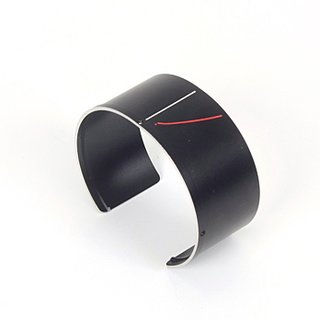 An old camera lens is upcycled into a fashionable cuff.