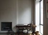 On the parlor level, the distinctive pigmented plaster walls eschews the finish of paint. Photo of Examples of Rustic Modern Done Right modern home