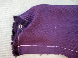 Once you've sewed the length of the strap, stick a safety pin through one end and begin to (slowly) guide it through to the other, turning the whole piece inside-out. Which will actually be rightside out.
