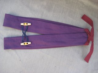 Ta-da! I sewed a couple buttons on and loosely crisscrossed the faux-suede between the two, but this is purely decorative. You can embellish these babies however you'd like—more buttons, embroidery, badges—and using a patterned fabric will also give a bit of a different feel.