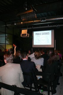 At the back of the showroom, a large crowd gathered.