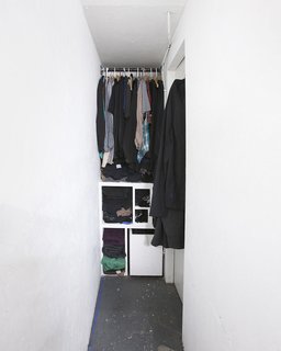Every leftover space was put to use. Here, a narrow slot behind the structure allows just enough room for a tight walk-in closet.