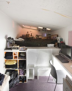 Located at the rear corner of the installation, down a progressively narrowing hallway, and reached by a steep staircase, Eric Juron’s attic-like space is the most remote of the bedrooms. A window over his desk looks down through the gap between the Major and the Minor.