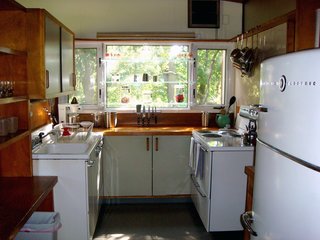 The kitchen is one of the most unified spaces in the house, thanks to the appliances. "Within a week of each other, we found the 1949 GE stove on E-Bay that matched the fridge," says Miller. "They were the same model of appliances that were used in the exhibition house; they matched the pictures exactly. The owner even had the original instruction booklet and the appliances were in pristine condition. It was an amazing discovery." Photo by Diana Budds.