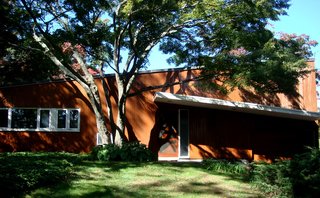 The rear facade of the house showing the slope of the butterfly roof. Photo by Diana Budds.
