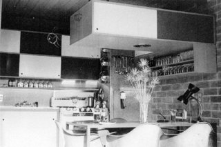 The original kitchen was a little pocket kitchen with a small dining area and overhead cabinet.