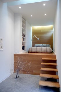 The master bedroom occupies a long, slender space on two levels. "If I’d taken the platform out, there’d be no differentiation," Shoup explains. "I wanted some sense of definition without putting up walls." Bamboo was used for the stairs, walls and platform. Photo by building Lab inc.