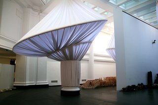 Brooklyn Museum's reOrder - Photo 11 of 12 - The marriage of columns and fabric came through independent studies of each. The fluting of Roman and Greek columns inspired, in part, the pleating of the fabric. The giant rings are also reflective of the early 18th century caged crinoline, or hoop skirt, a popular fashion at the time of the building’s original construction.