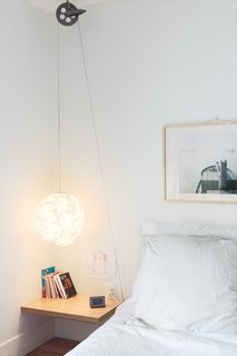 Reel Simple<br><br>For a simple, low-cost bedside reading light with a dash of industrial style, Bernier ran a standard-issue cord set through a vintage clothesline pulley, which he picked up at a flea market, on Thibault’s side of the bed. "If she ever wants it to be higher, she can easily adjust it," he says.