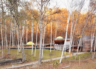 A Platform for Living - Photo 3 of 28 - The long, lean Kobayashi complex includes a bathroom and storage room in the structure on the far right.