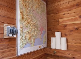 A Platform for Living - Photo 20 of 28 - A peek inside the bathroom, where a raised topographic map doubles as reading material and travel inspiration.